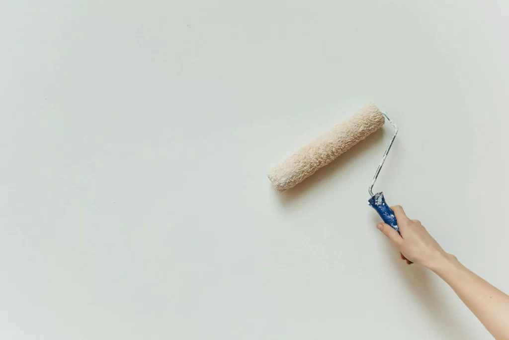 Close-up of a professional painter finishing a residential living room in Nottingham.
